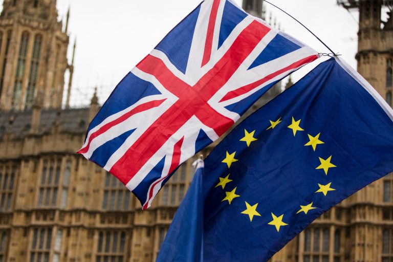 UK and EU Relations Explained: A Complete Guide to Trade, Travel and Regulation United Kingdom and European Union flags flying side by side against a stormy sky. UK and EU relations explained